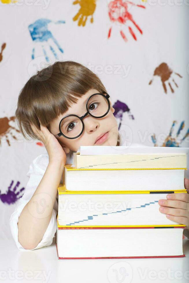 Boy of seven years old with books. Back to school photo