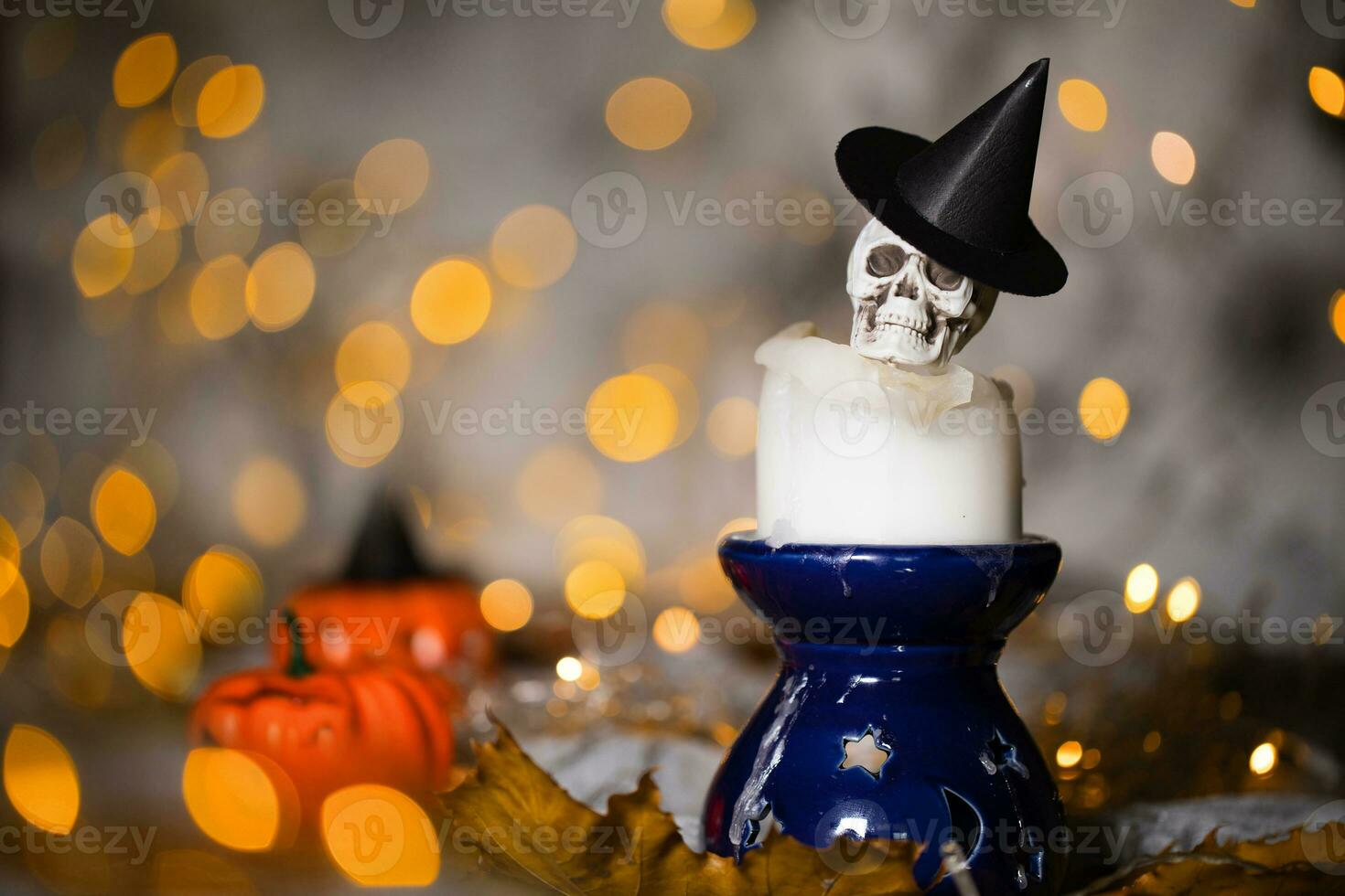 Skull on an used old candle. Closeup. photo