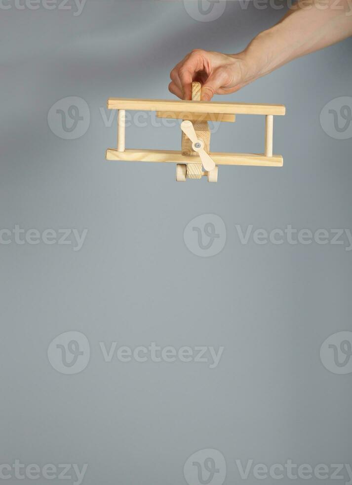 Woodenmade airplane on a gray background. photo