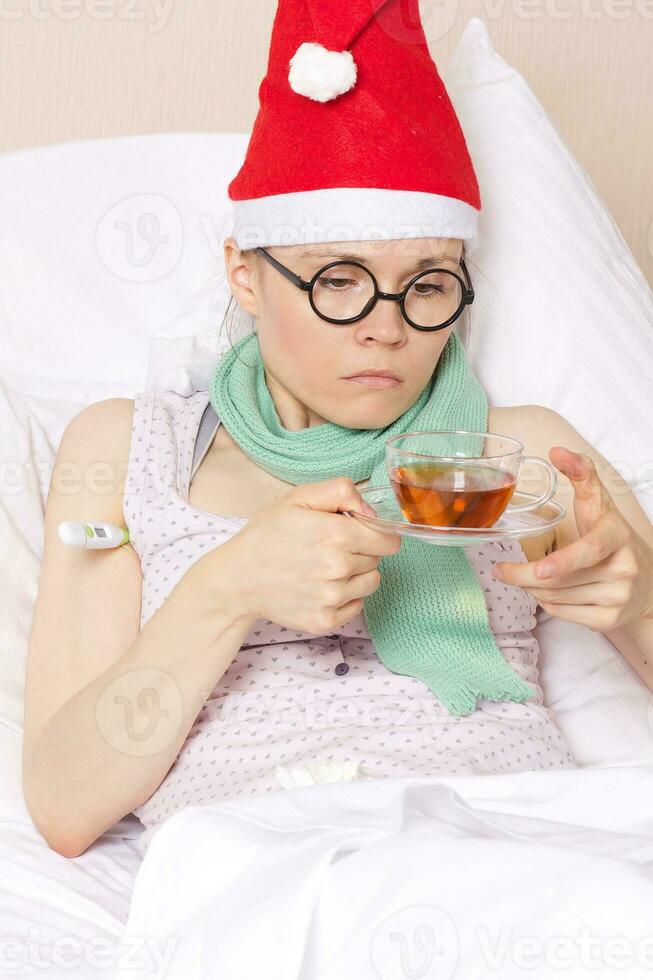 Sick young lady in her bed photo