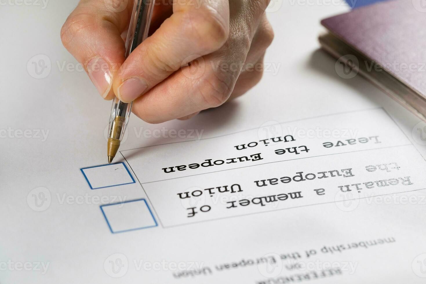 Referendum ballot paper, black pen, and passport on the table. photo