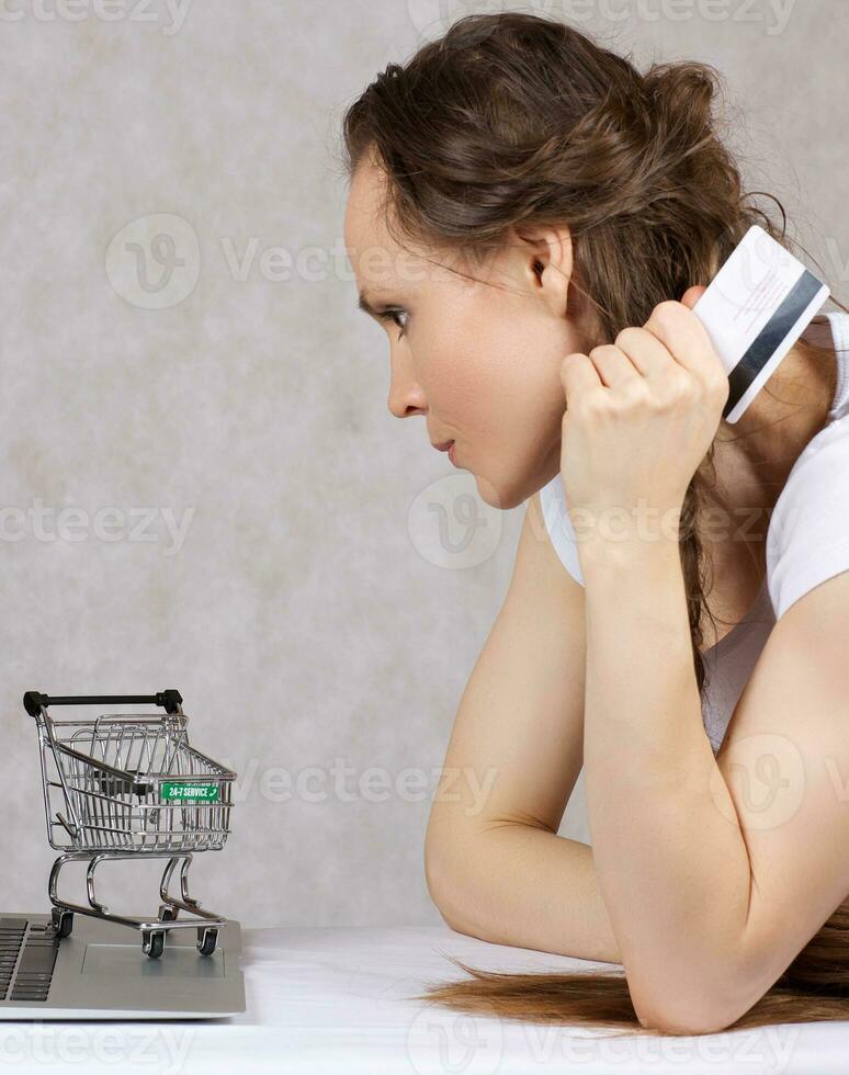 Young lady is shopping online photo