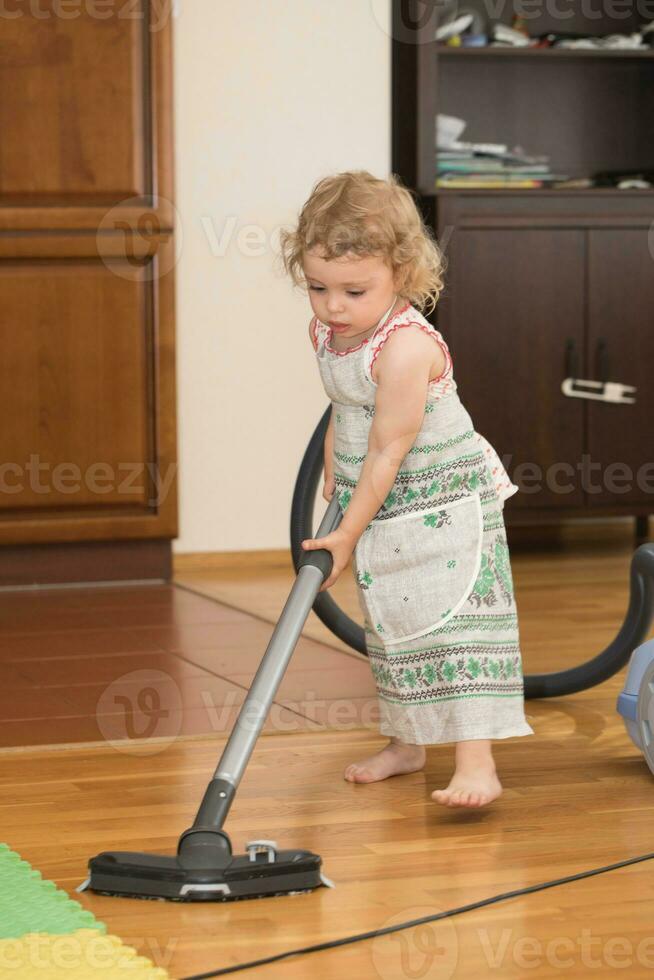 pequeño niña es limpieza departamento. de cerca foto