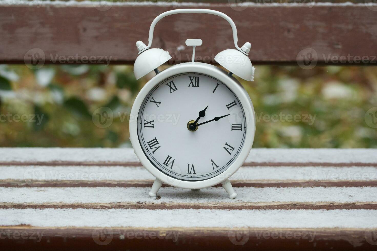 Vintage clock on a bench photo