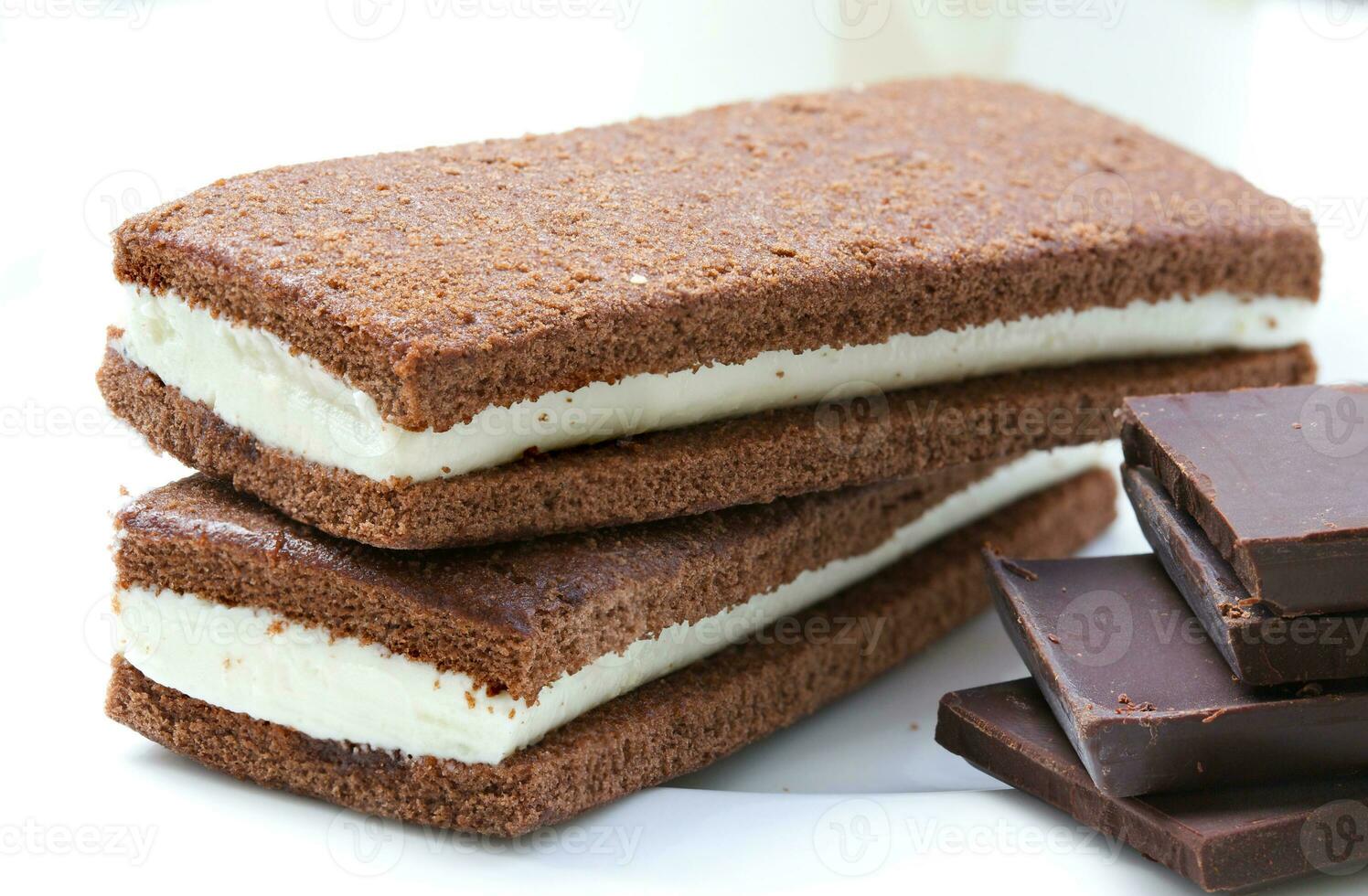 Homemade chocolate sponge cake with fluffy milky filling. Closeup photo