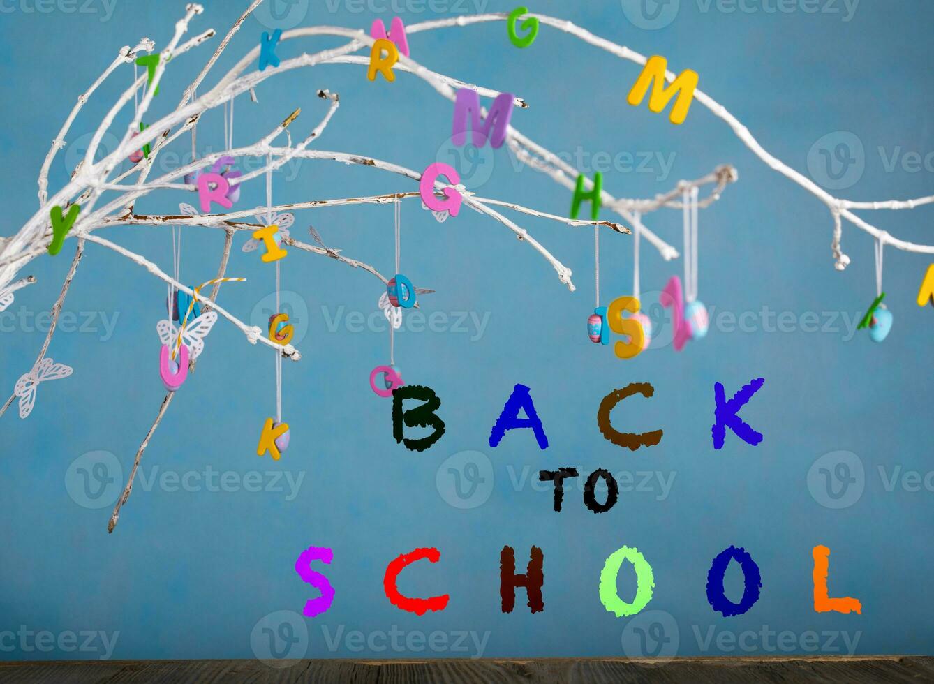 Colorful letters on tree twigs. photo