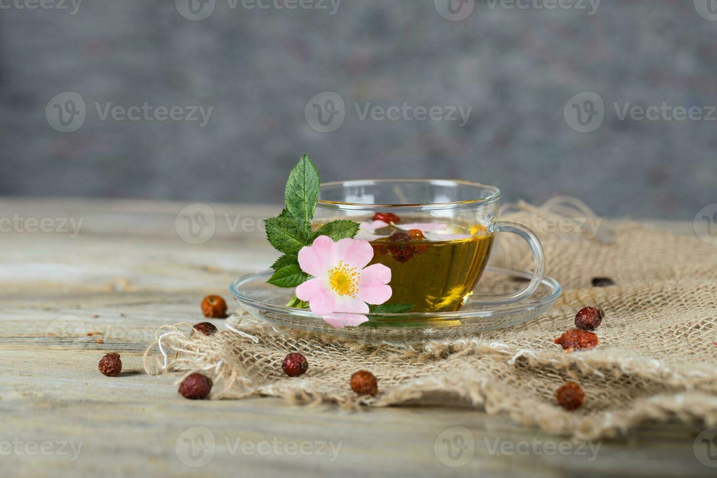 Rose hip herbal tea on a wooden surface. Free text. photo