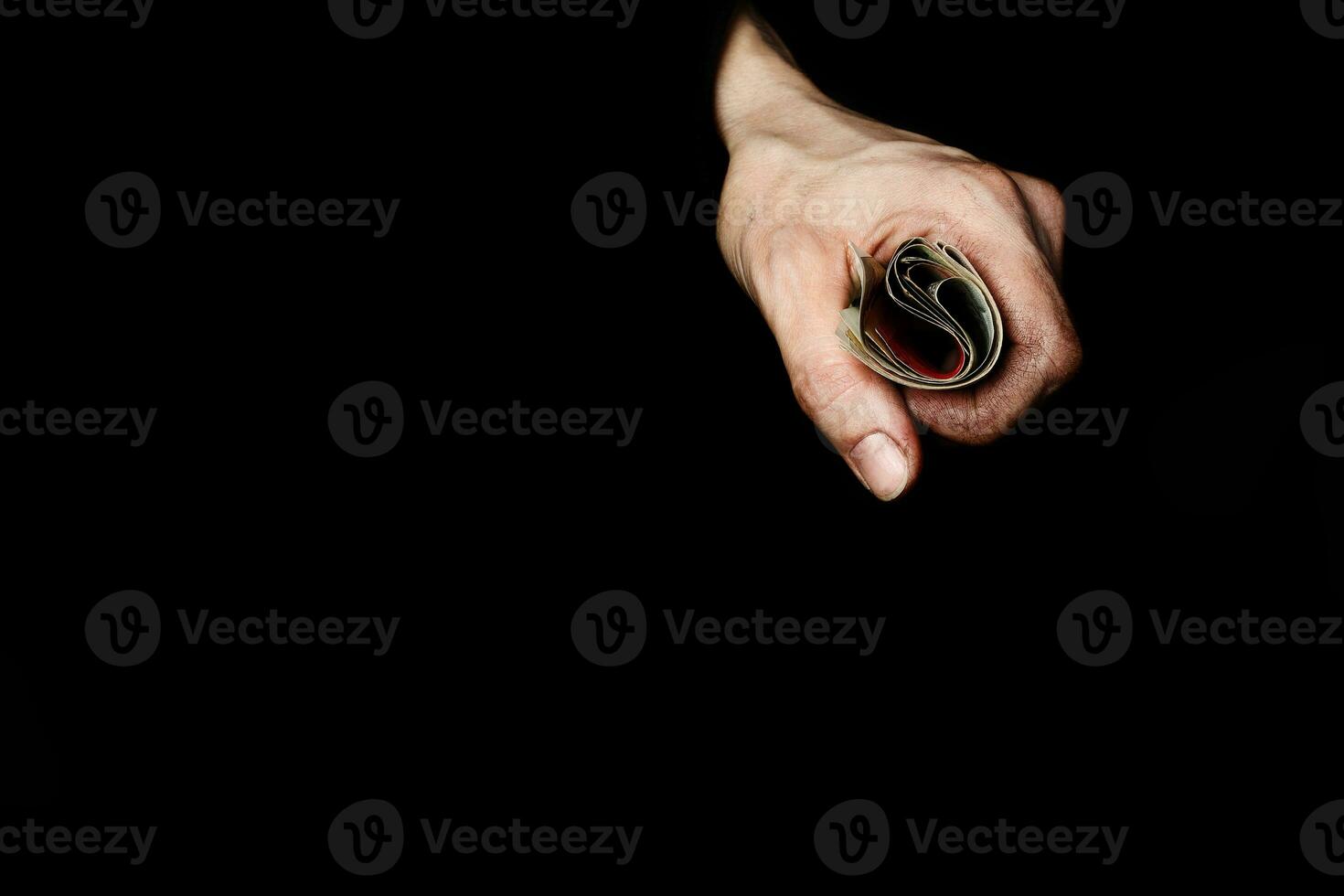 Palm of a peasant woman with old banknotes on a black fabric. Closeup photo