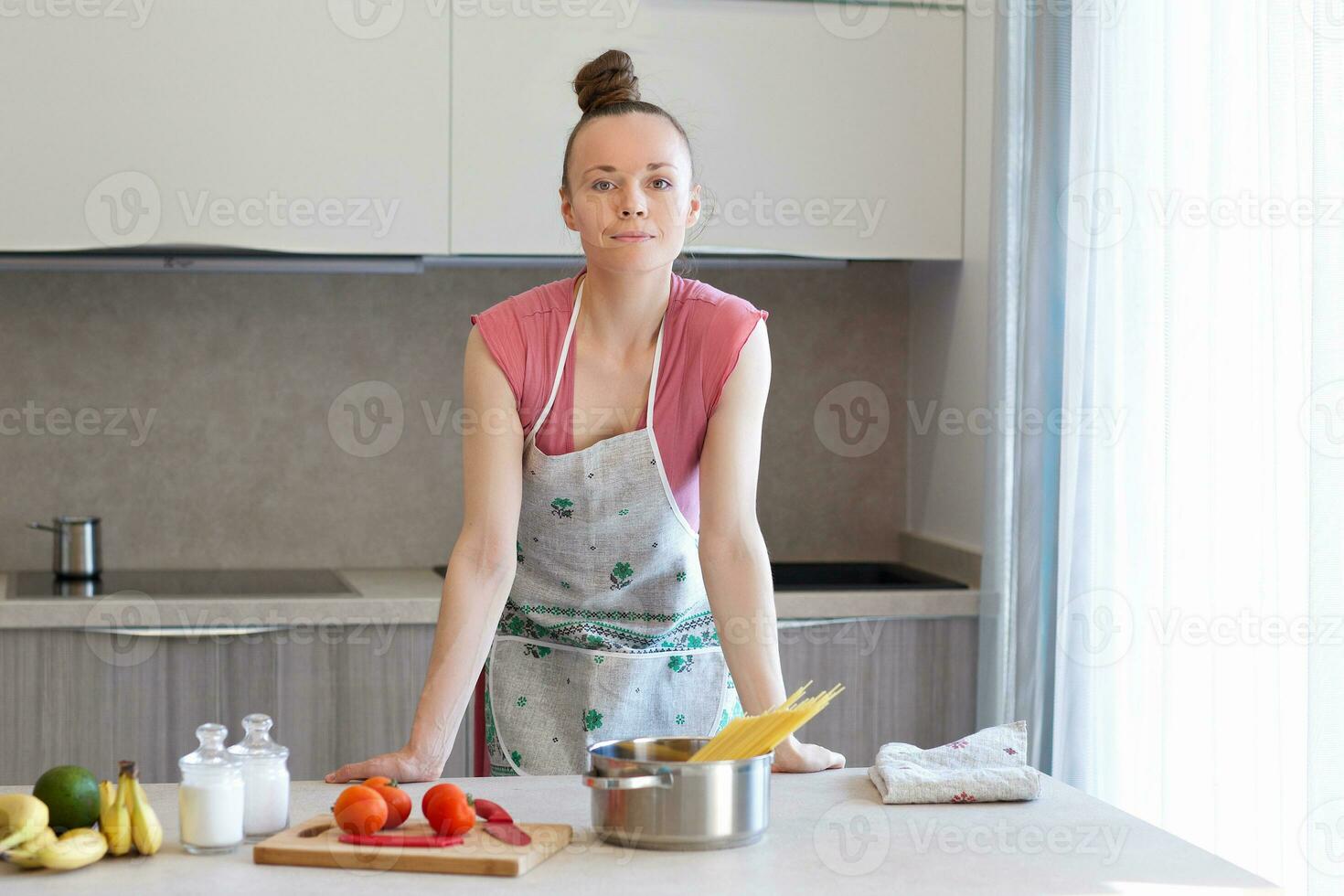 Young housewife in the kitchen photo