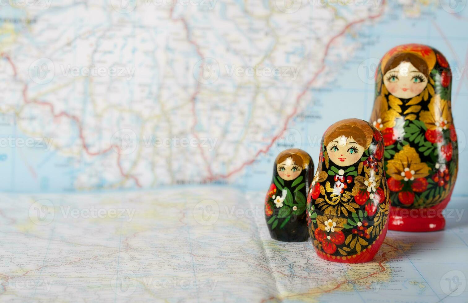 Russian matryoshka in khokhloma style on a map. Closeup photo