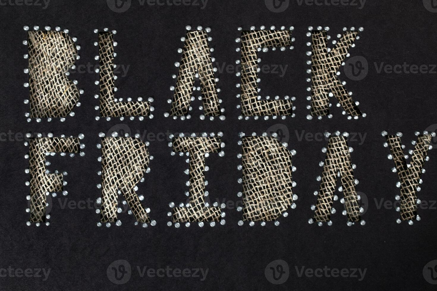 Words BLACK FRIDAY are cut out from black carton paper. photo