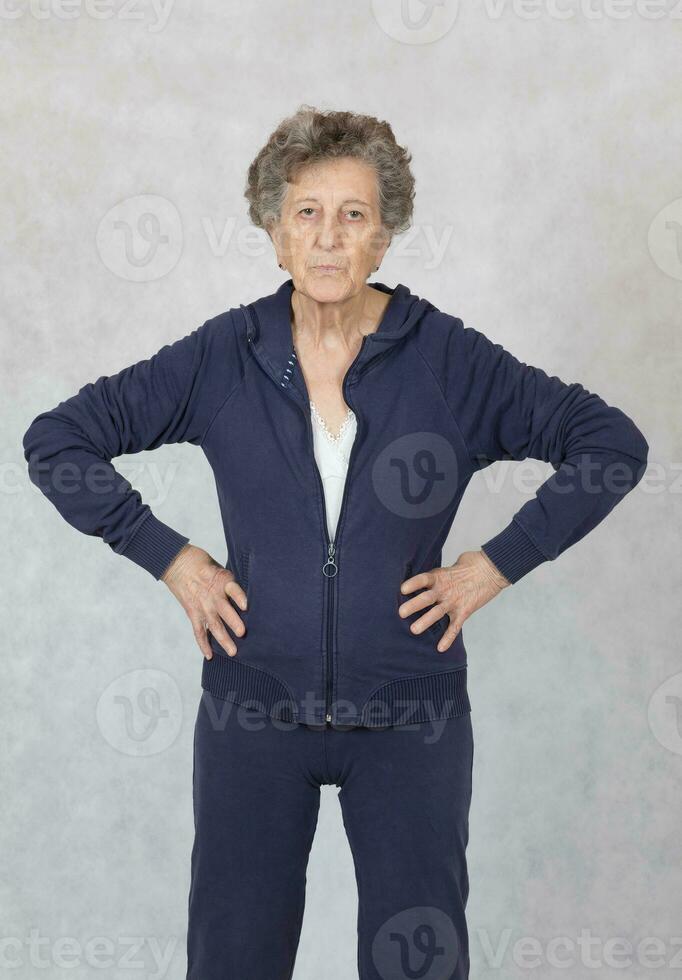 Senior woman is dressed in a sport costume photo