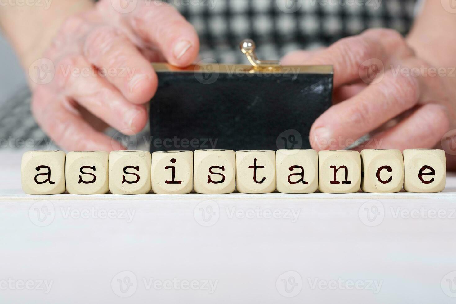 Word ASSISTANCE composed of  wooden dices. photo