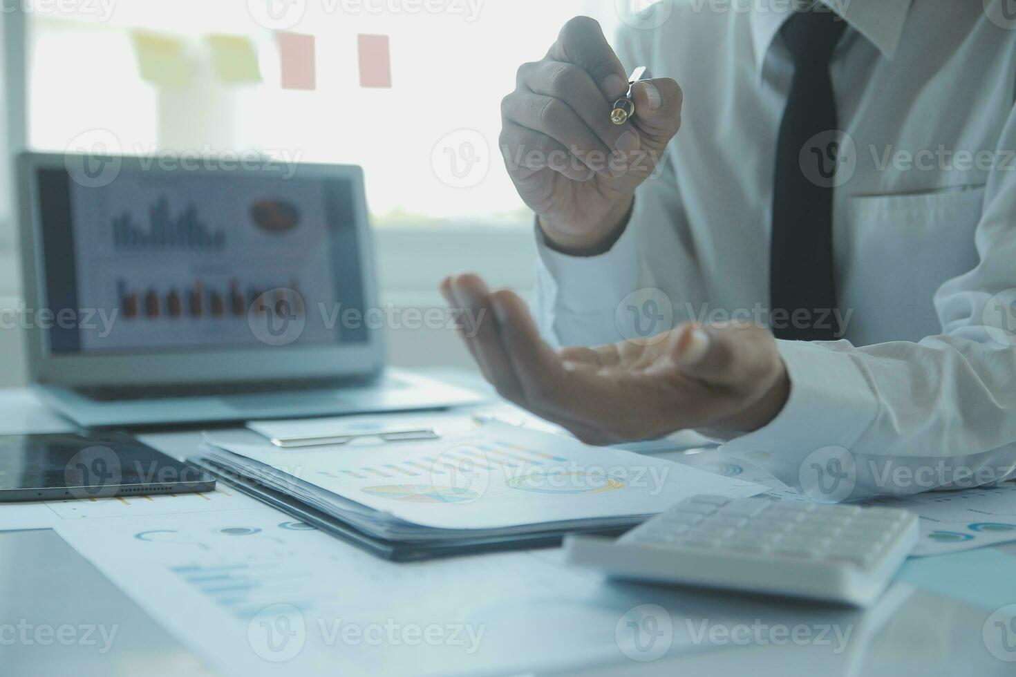 Close up businessman hand using calculator and working with laptop calculate about finance accounting at coffeeshop outdor.finance accounting concept photo