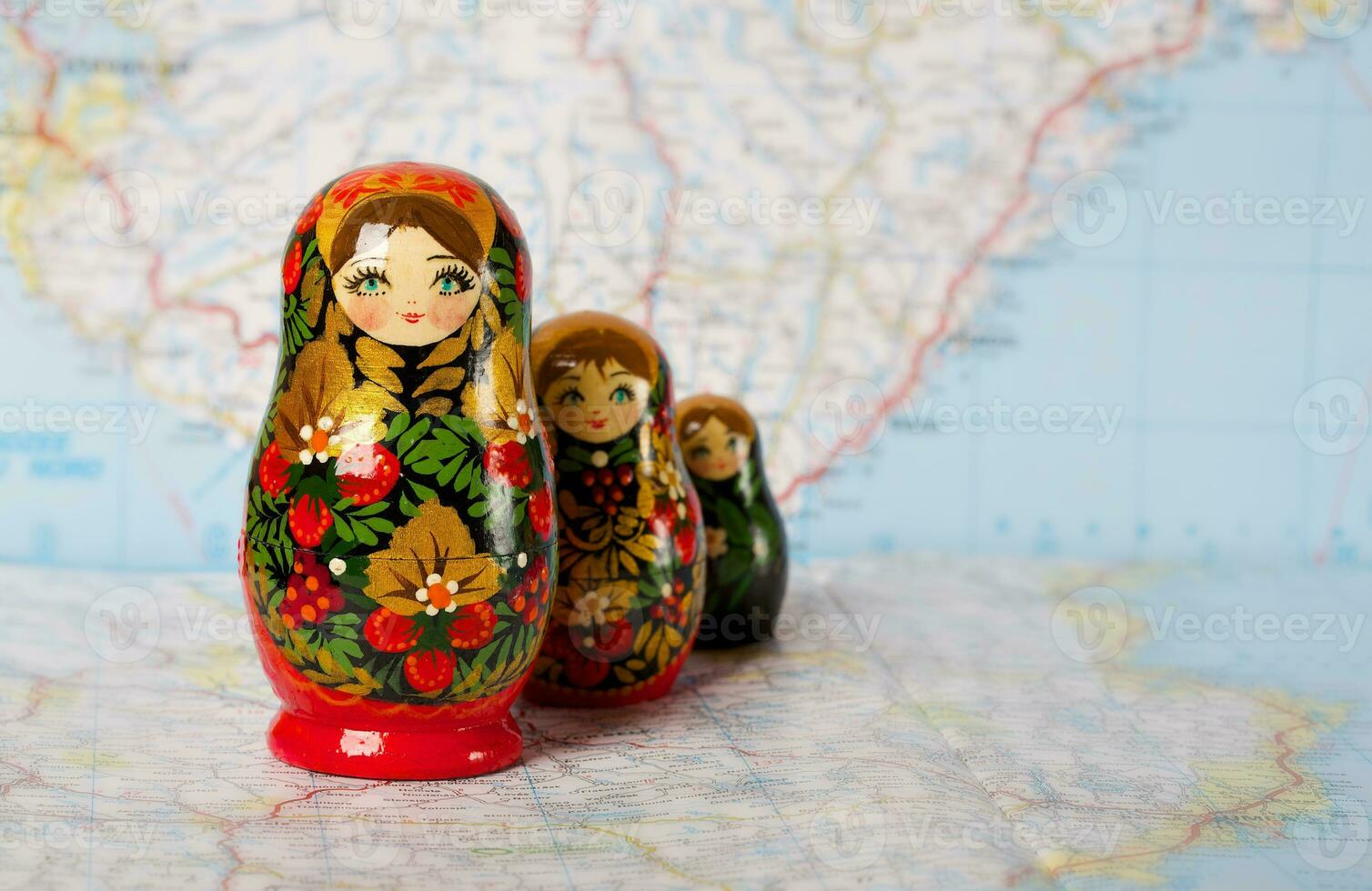 Russian matryoshka in khokhloma style on a map. Closeup photo