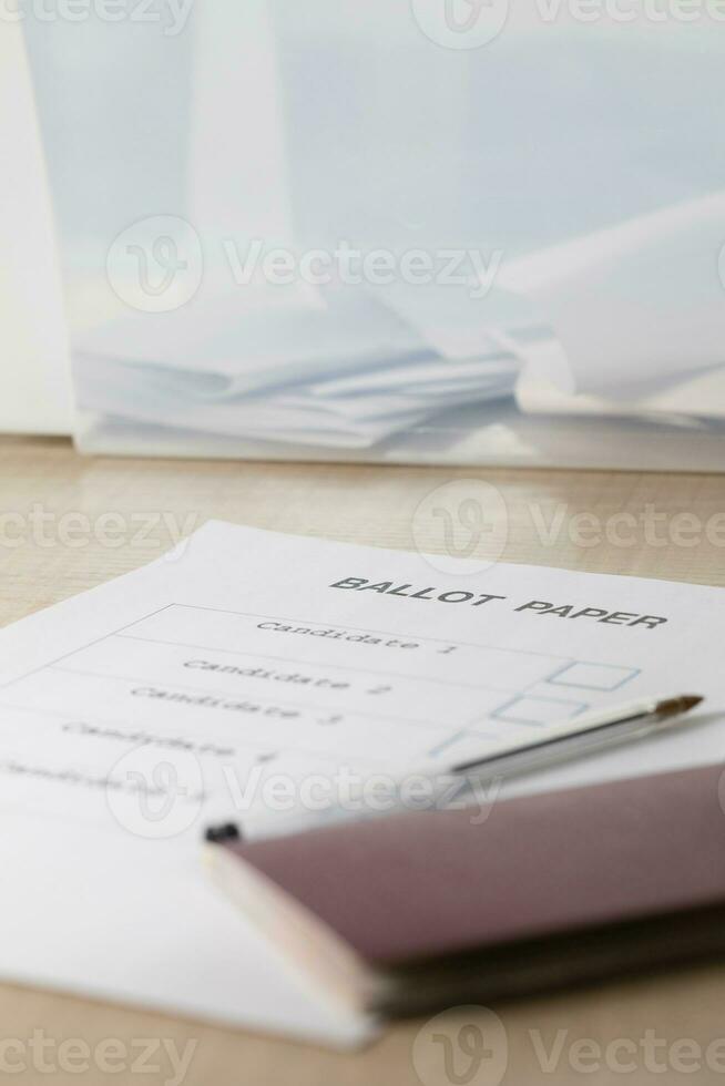 Ballot paper, black pen, pass on the table in front of ballot box. photo