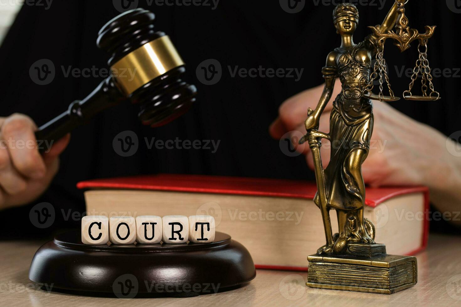 Word  COURT composed of wooden dices. Wooden gavel and statue of Themis in the background. photo
