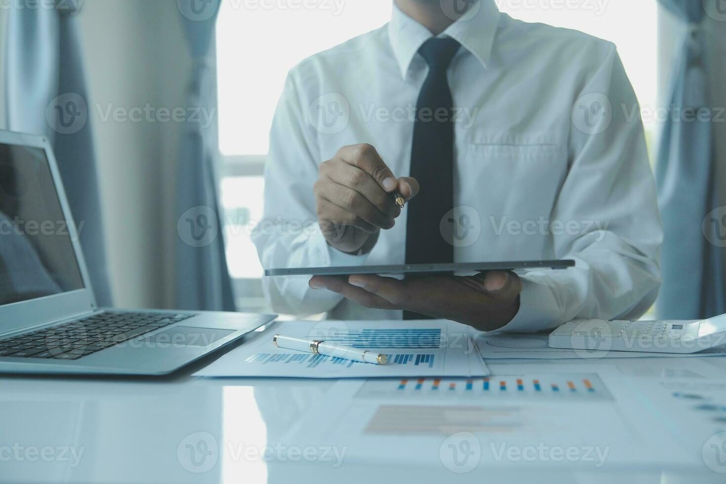 Close up businessman hand using calculator and working with laptop calculate about finance accounting at coffeeshop outdor.finance accounting concept photo