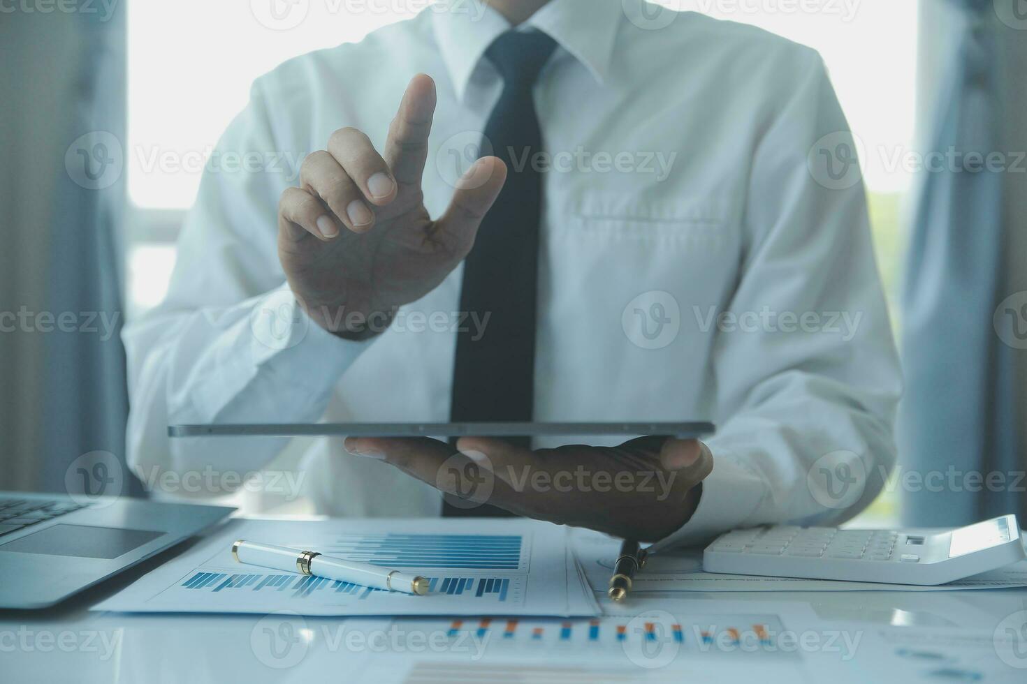 Close up businessman hand using calculator and working with laptop calculate about finance accounting at coffeeshop outdor.finance accounting concept photo