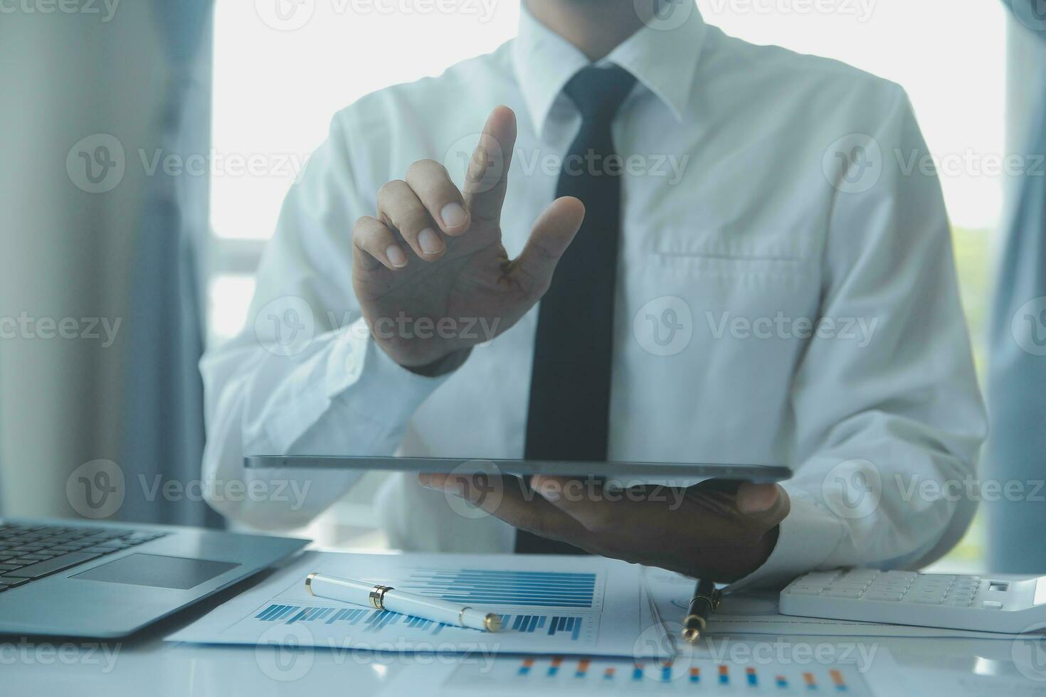 Close up businessman hand using calculator and working with laptop calculate about finance accounting at coffeeshop outdor.finance accounting concept photo
