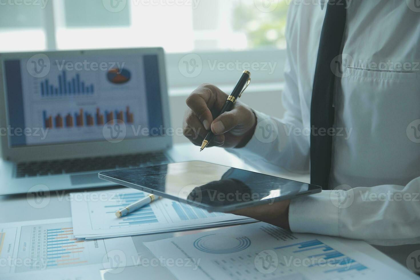 Close up businessman hand using calculator and working with laptop calculate about finance accounting at coffeeshop outdor.finance accounting concept photo
