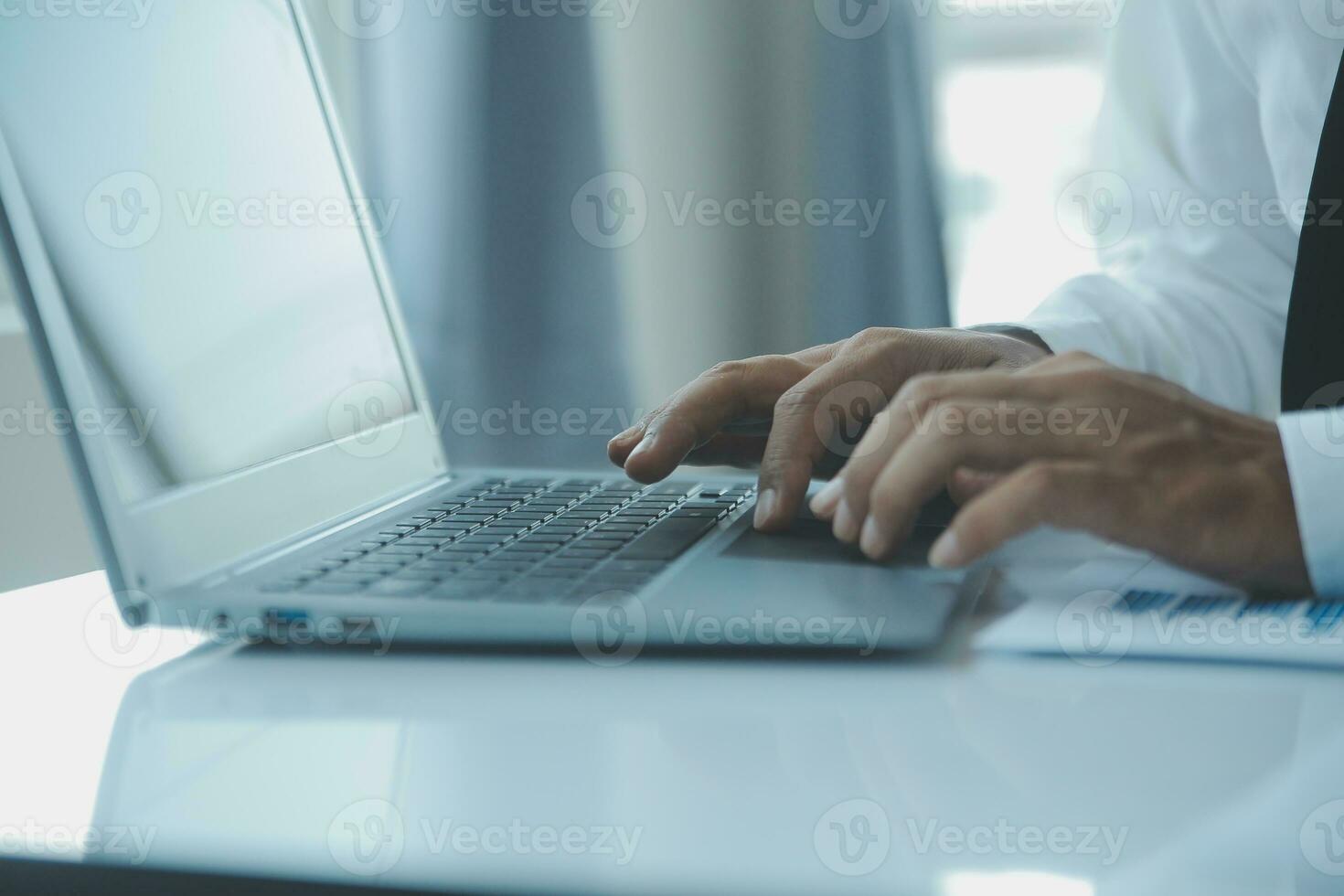 Close up businessman hand using calculator and working with laptop calculate about finance accounting at coffeeshop outdor.finance accounting concept photo