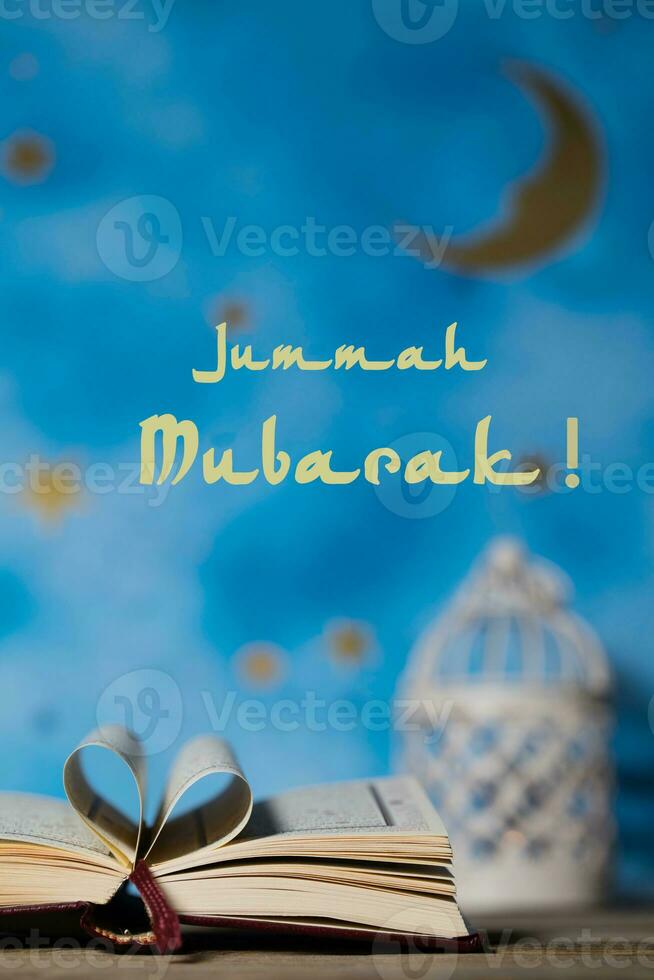 Jummah Mubarak Happy Friday Sacred book of Quran on a wooden surface. photo