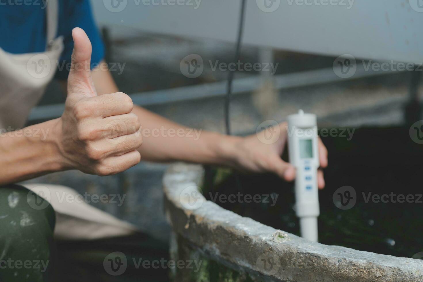 farmer with digital device checking on tablet with plantation. photo