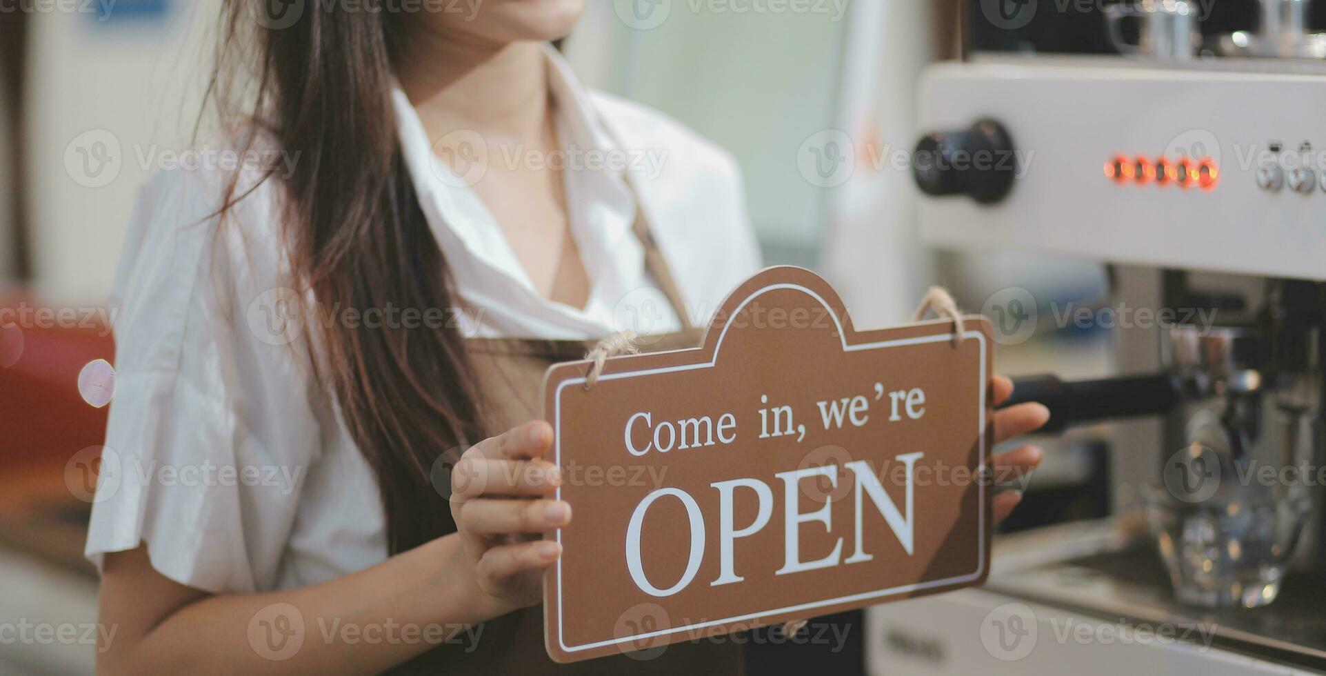 Open. barista, waitress woman wearing protection face mask turning open sign board on glass door in modern cafe coffee shop, cafe restaurant, retail store, small business owner, food and drink concept photo