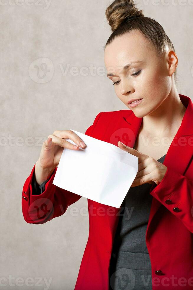 Young caucasian lady  keeps an envelope. Closeup photo