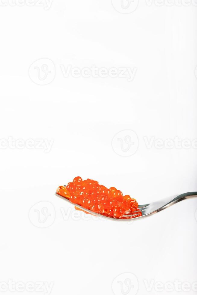 Red caviar on a metal fork. photo