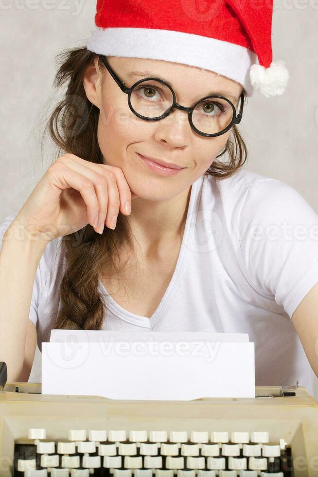 Young blogger with typing machine photo