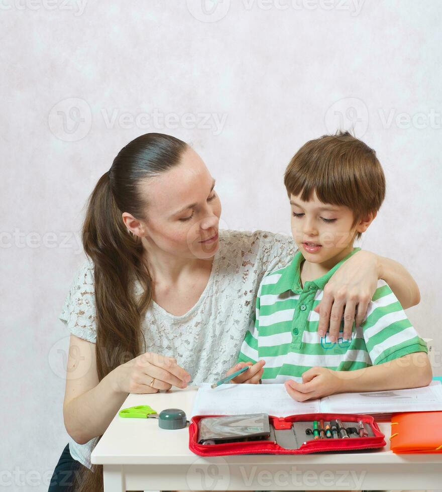 The mother checks the homework of her son photo