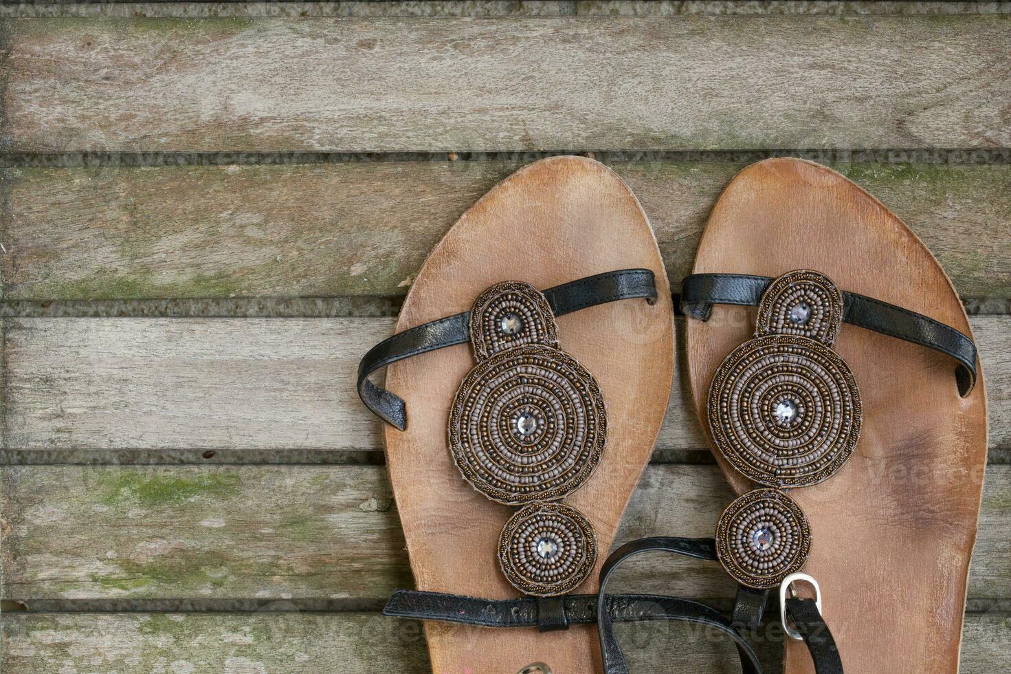 Womens summer shoes on a wooden surface. Background. photo
