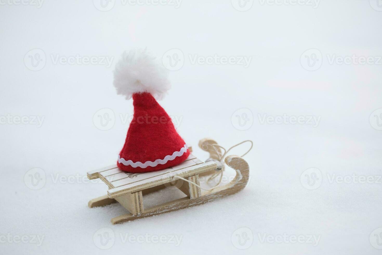 Santa Claus hat on a wooden made sleigh. photo