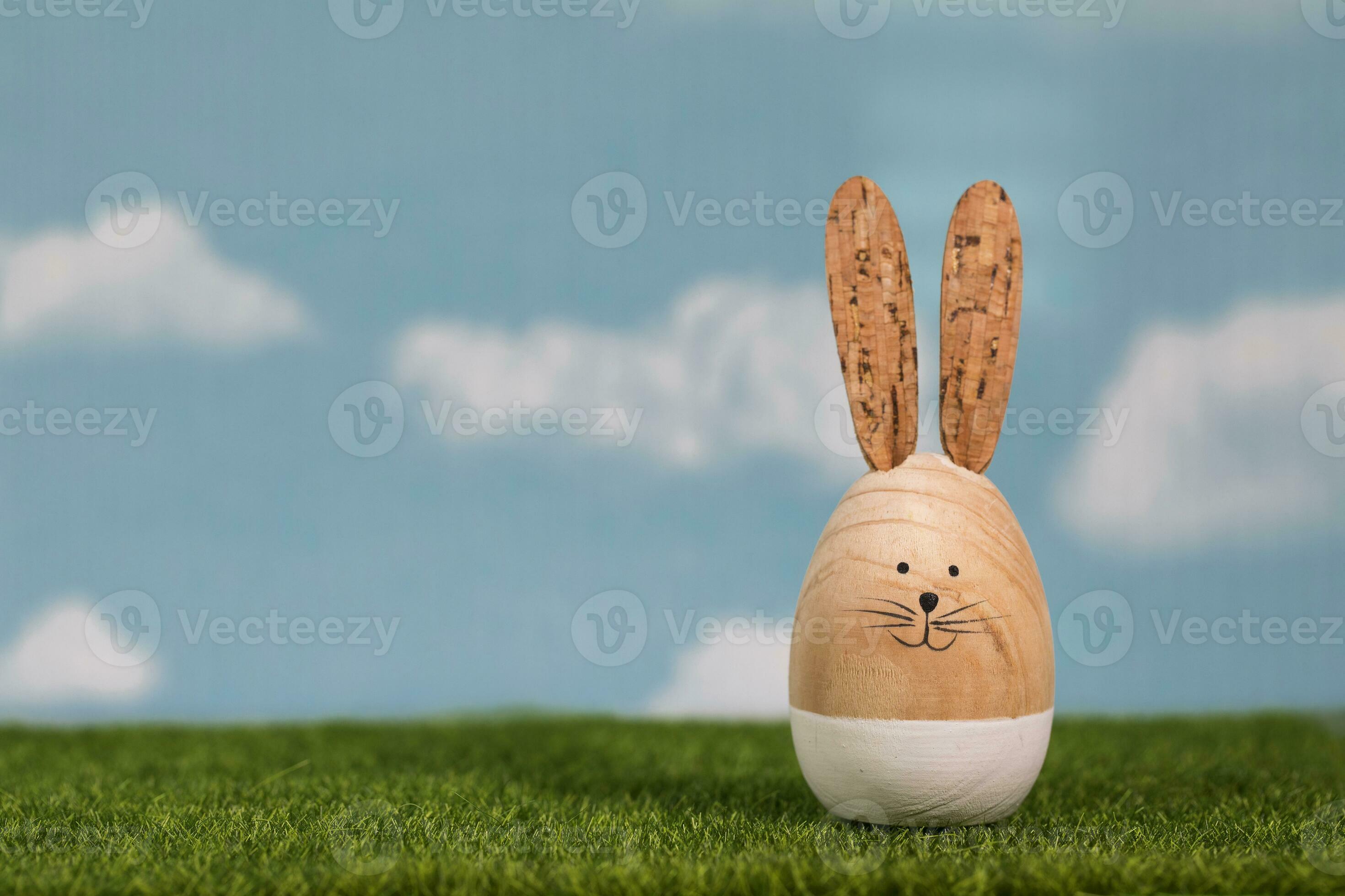 wooden-easter-bunny-on-an-artificial-grass-24988949-stock-photo-at