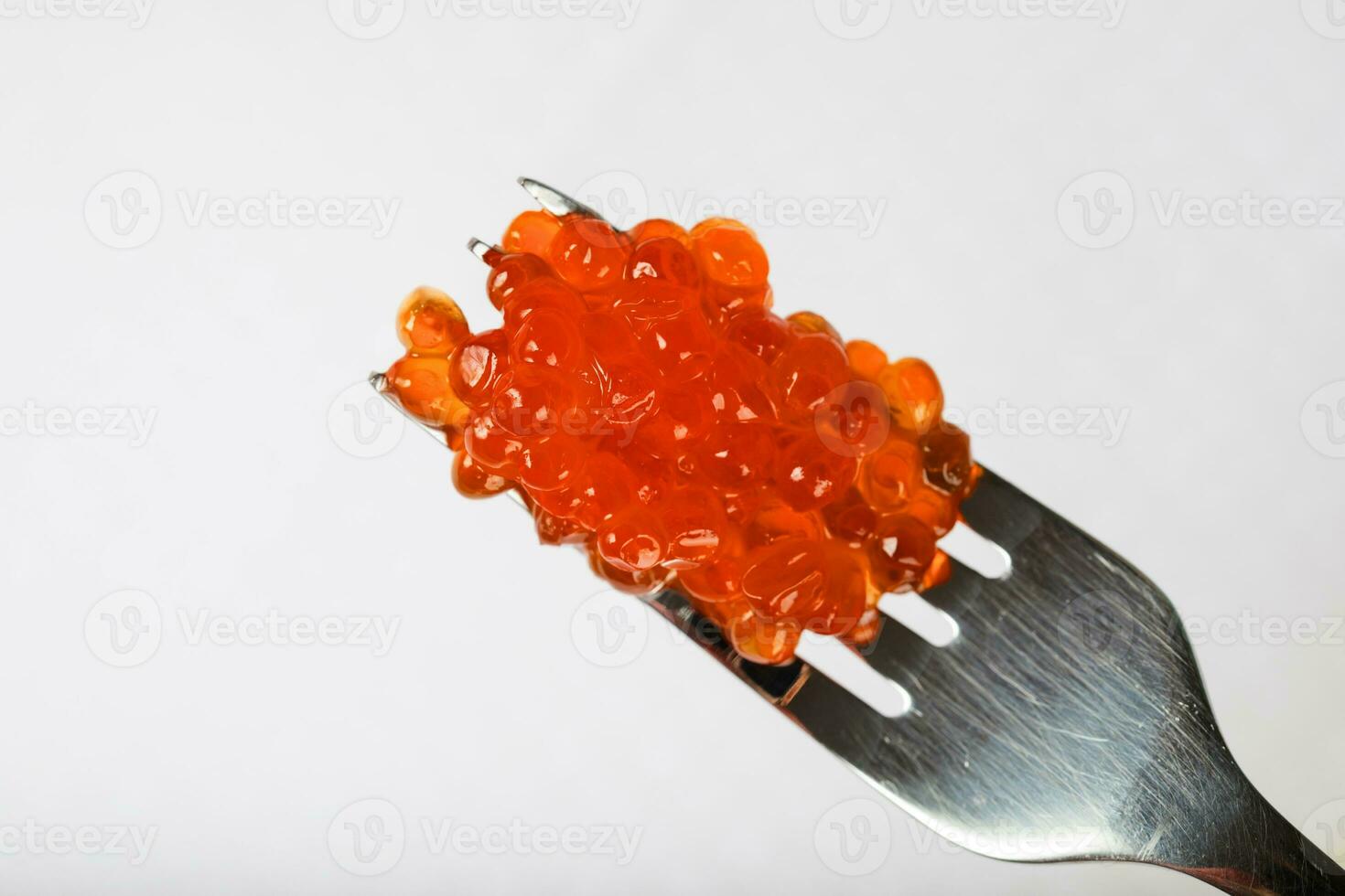 Red caviar on a metal fork. photo