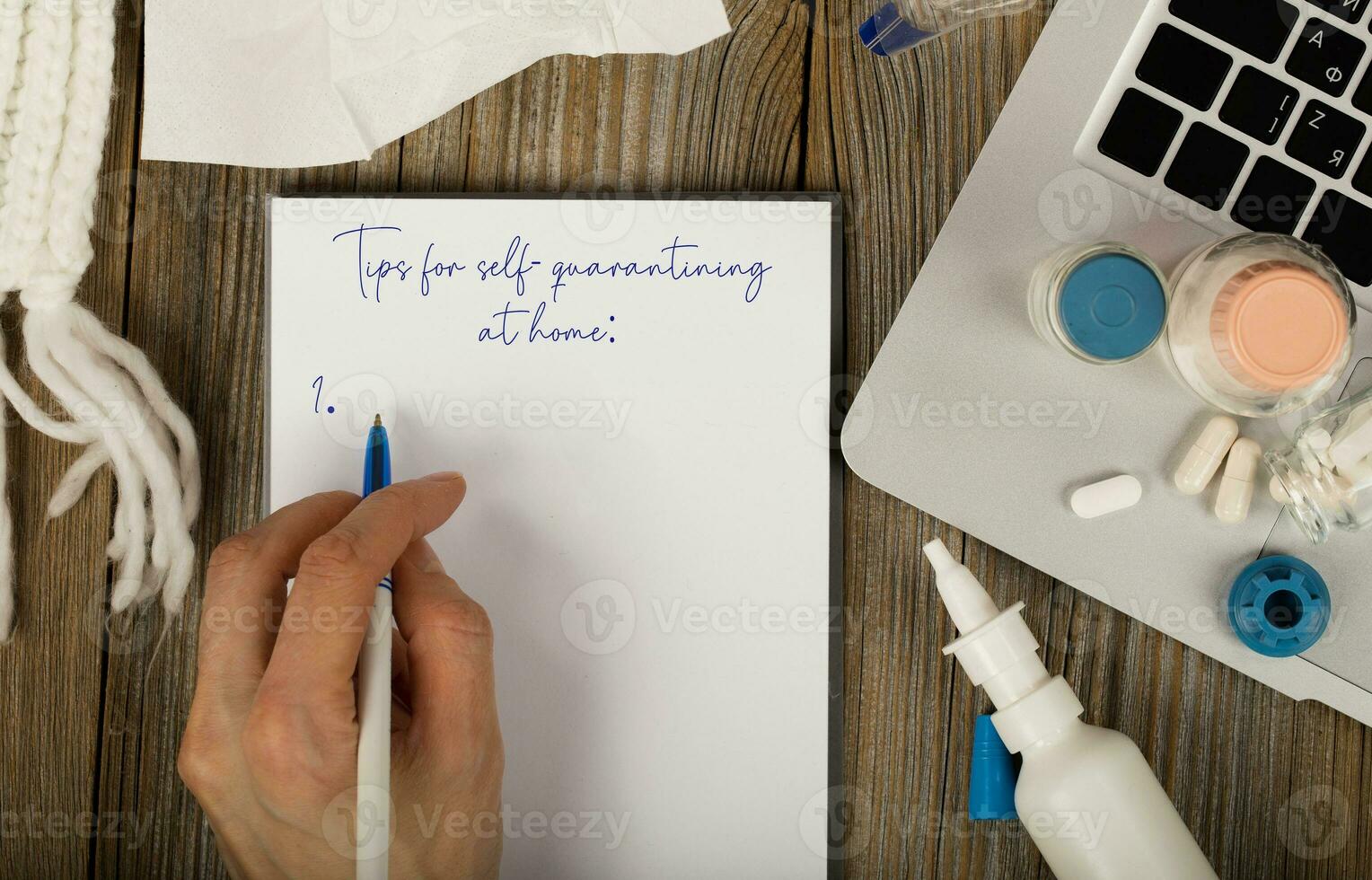 Tips for self-quarantining at home is written on a sheet of paper. photo