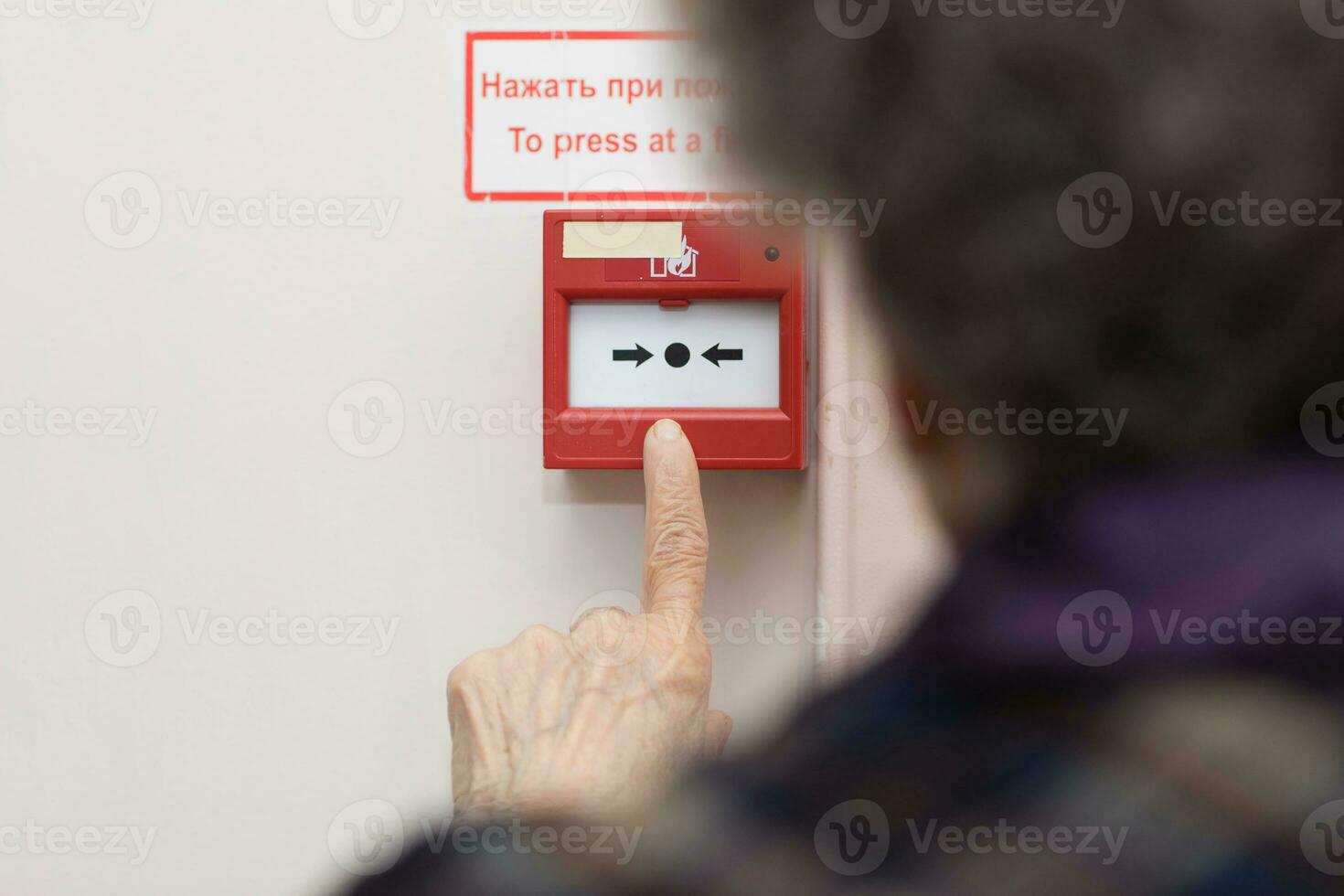 Senior woman wants to press an emergency button photo