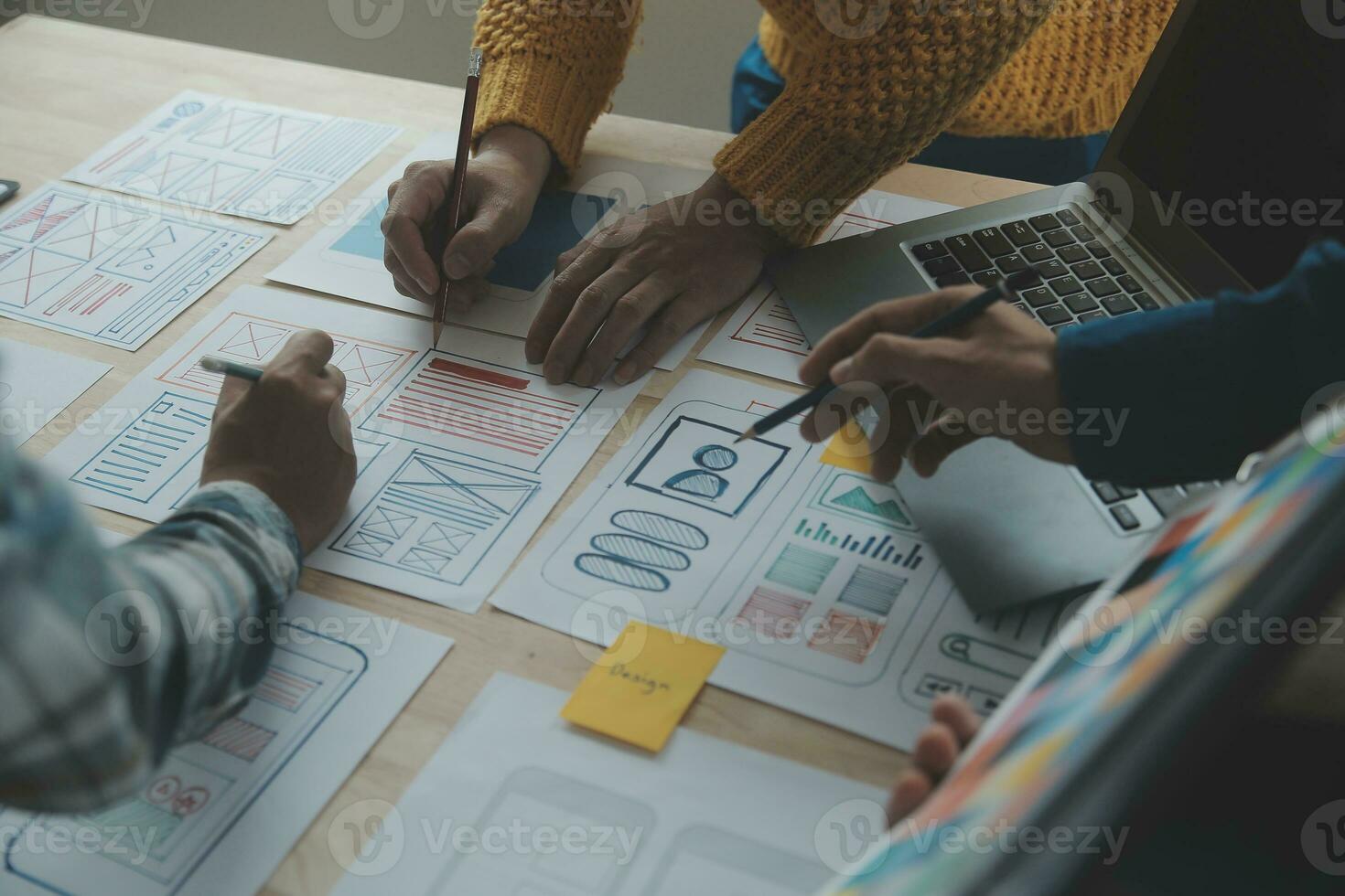 Close up ux developer and ui designer brainstorming about mobile app interface wireframe design on table with customer breif and color code at modern office.Creative digital development agency photo