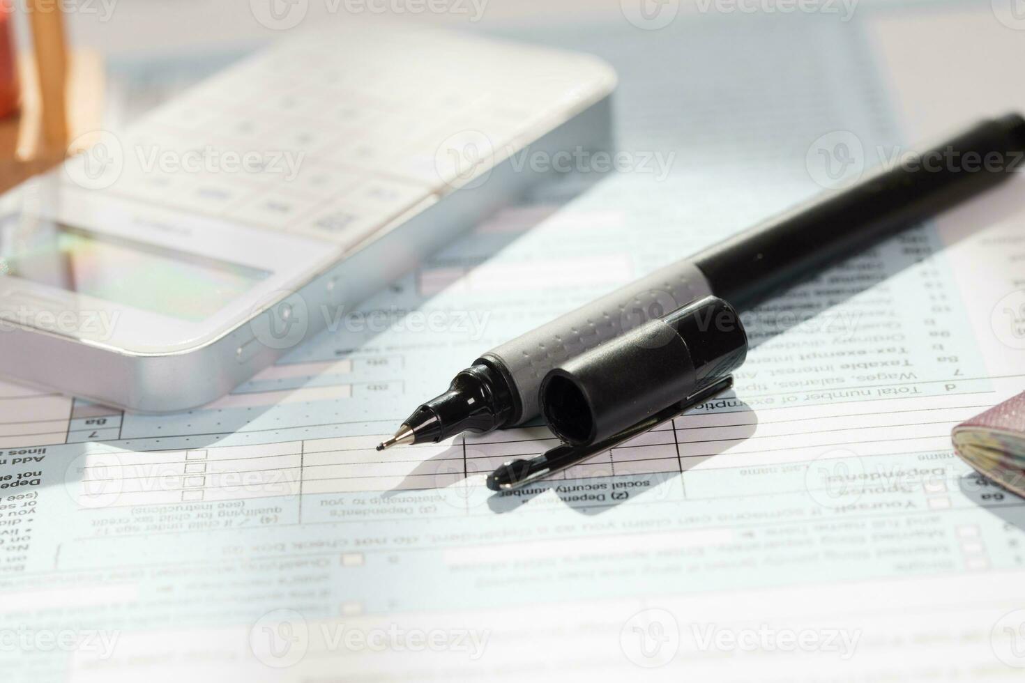 Black pen on a table for filling in the form. photo