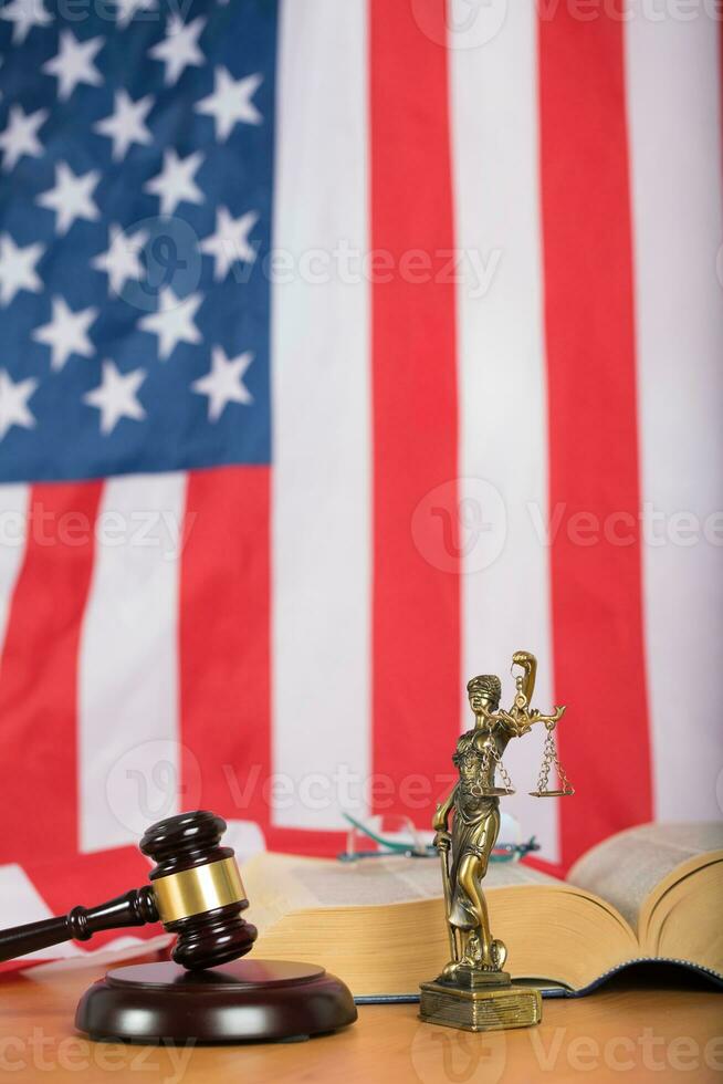 Statue of Themis and judge's gavel on a table. photo