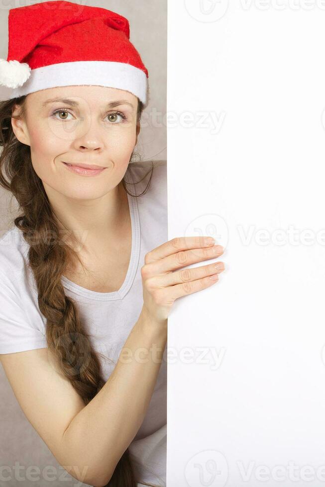 Young lady in Santa Claus hat photo