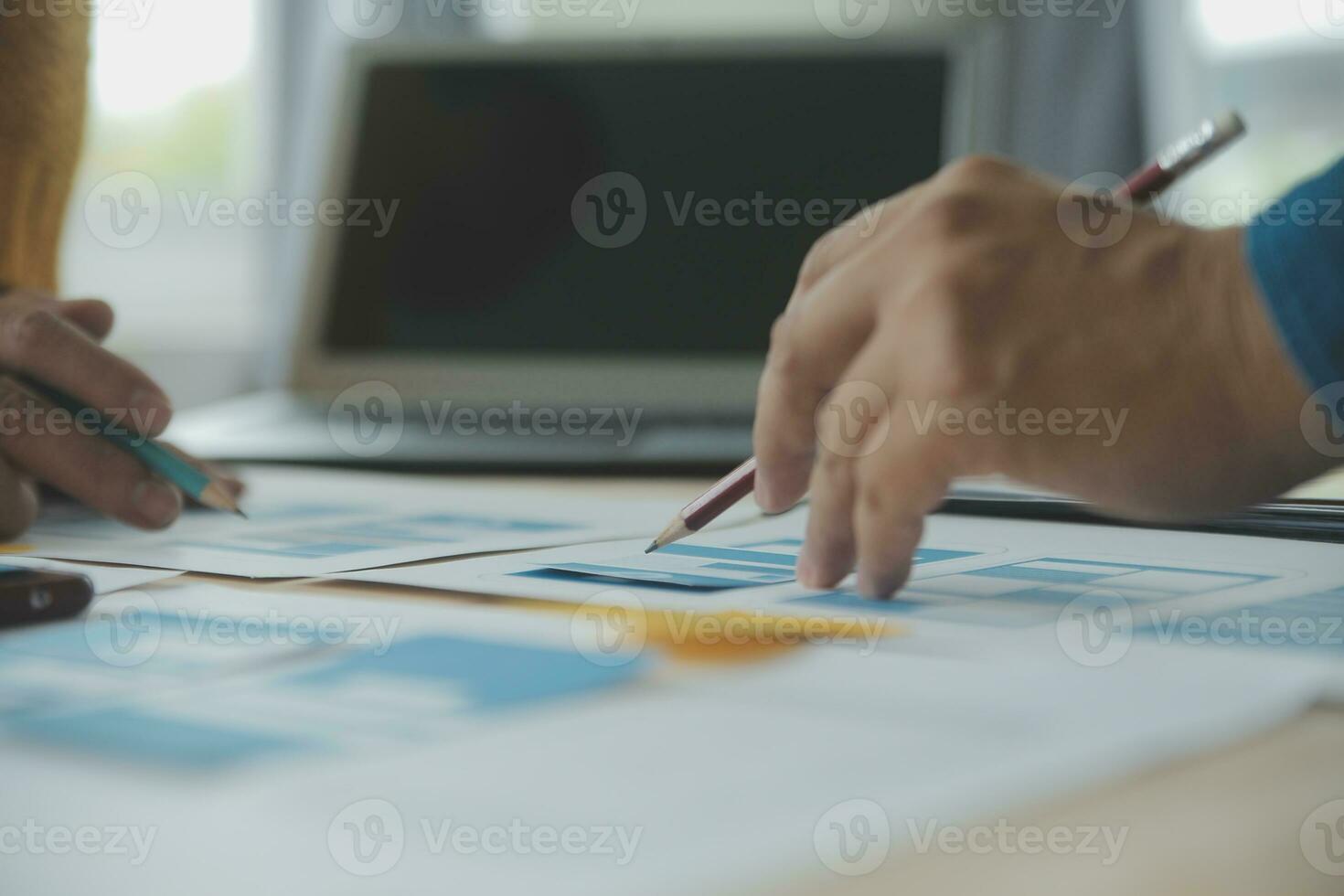 Close up ux developer and ui designer brainstorming about mobile app interface wireframe design on table with customer breif and color code at modern office.Creative digital development agency photo