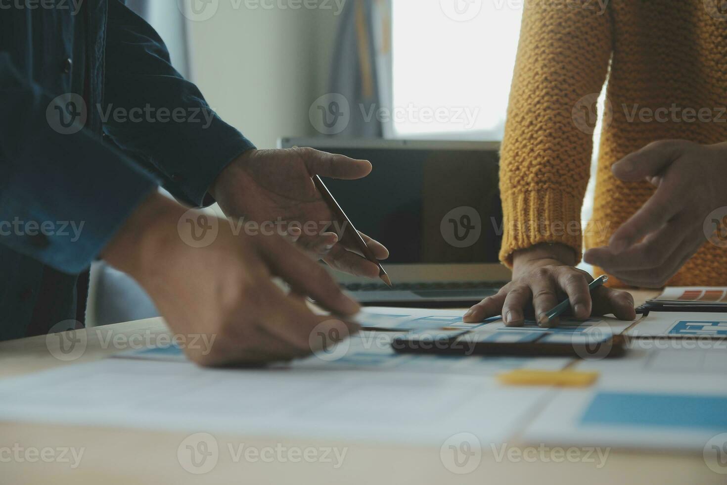 Close up ux developer and ui designer brainstorming about mobile app interface wireframe design on table with customer breif and color code at modern office.Creative digital development agency photo