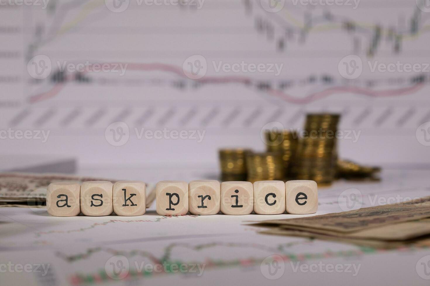 Words ASK PRICE composed of wooden letter. Stacks of coins in the background. photo