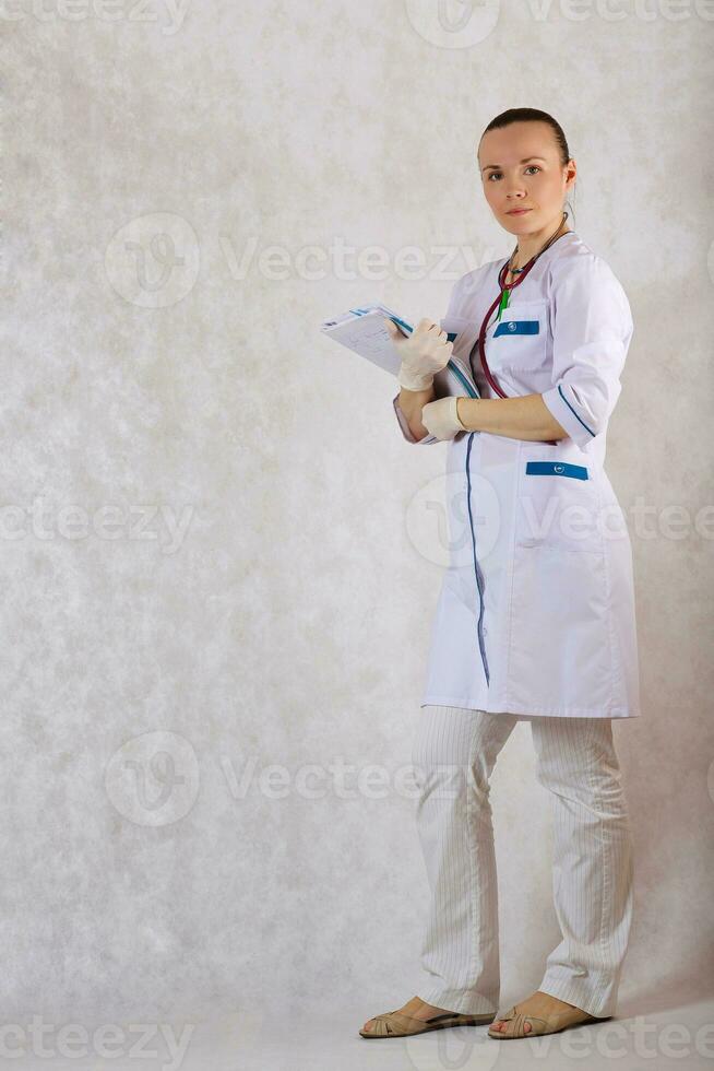 Doctor in a white professional uniform on a white background. photo