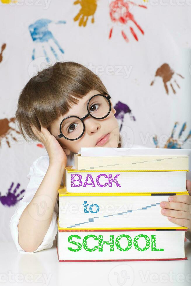 Boy of seven years old with books. Back to school photo