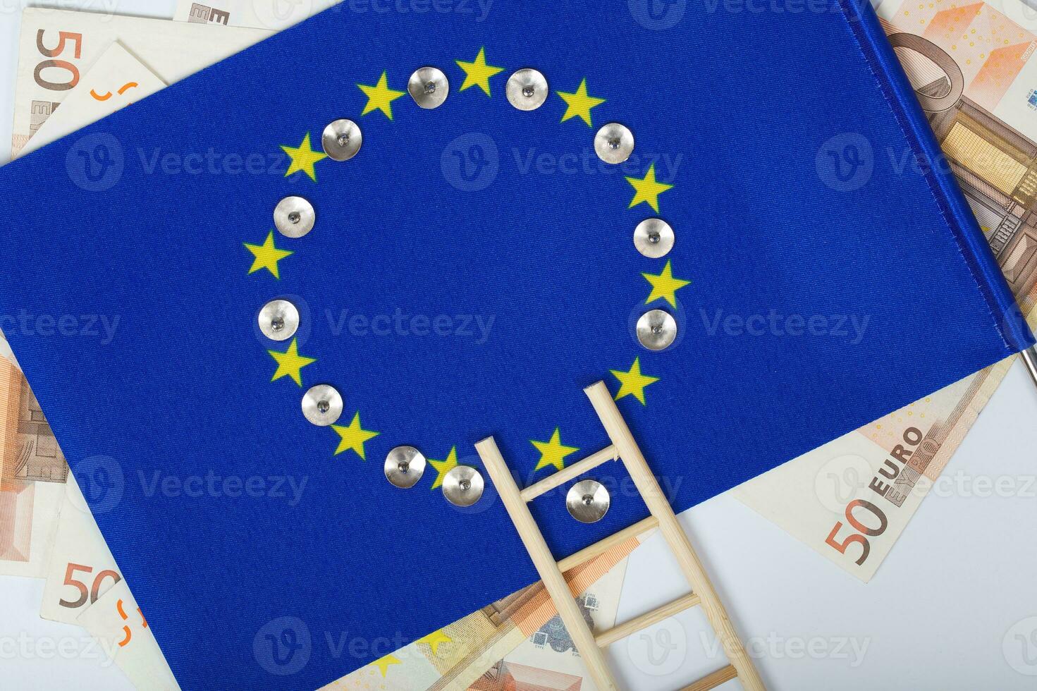 Ladder and pins on an European flag. Closeup photo