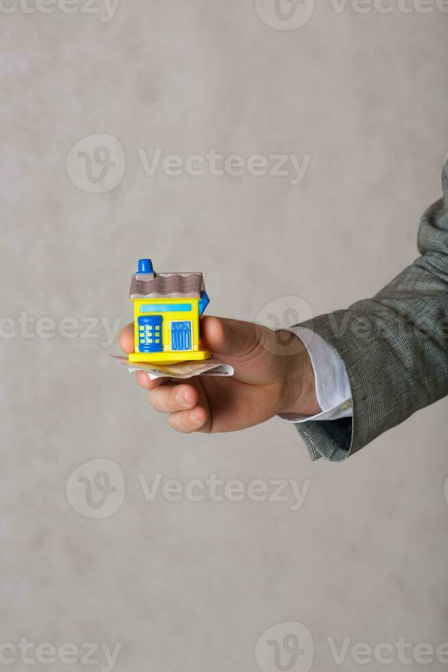 A man keeps a rubber house.Closeup photo